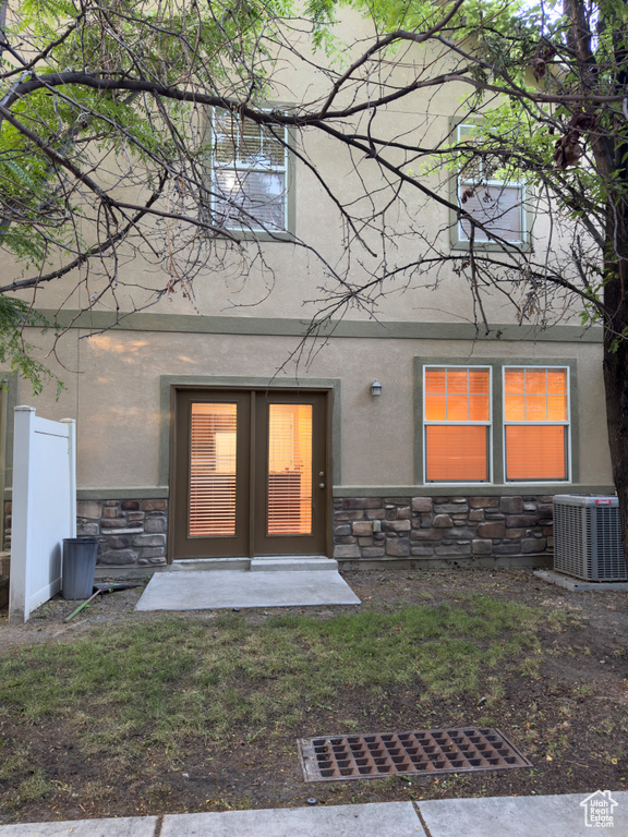 Doorway to property with stone siding and stucco siding