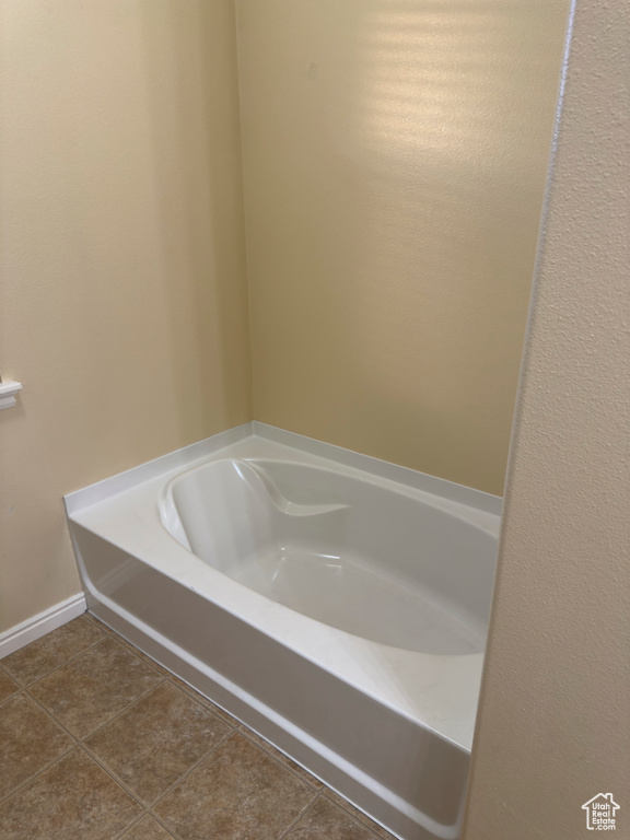 Full bathroom featuring a bath and tile patterned floors