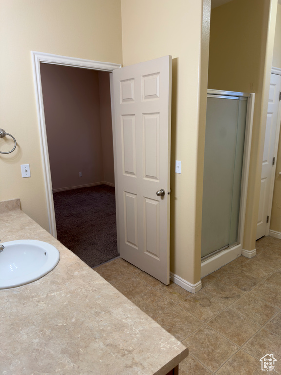 Bathroom featuring a stall shower and vanity