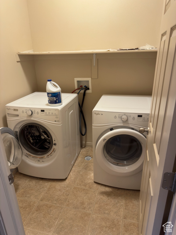Washroom featuring separate washer and dryer and light tile patterned floors