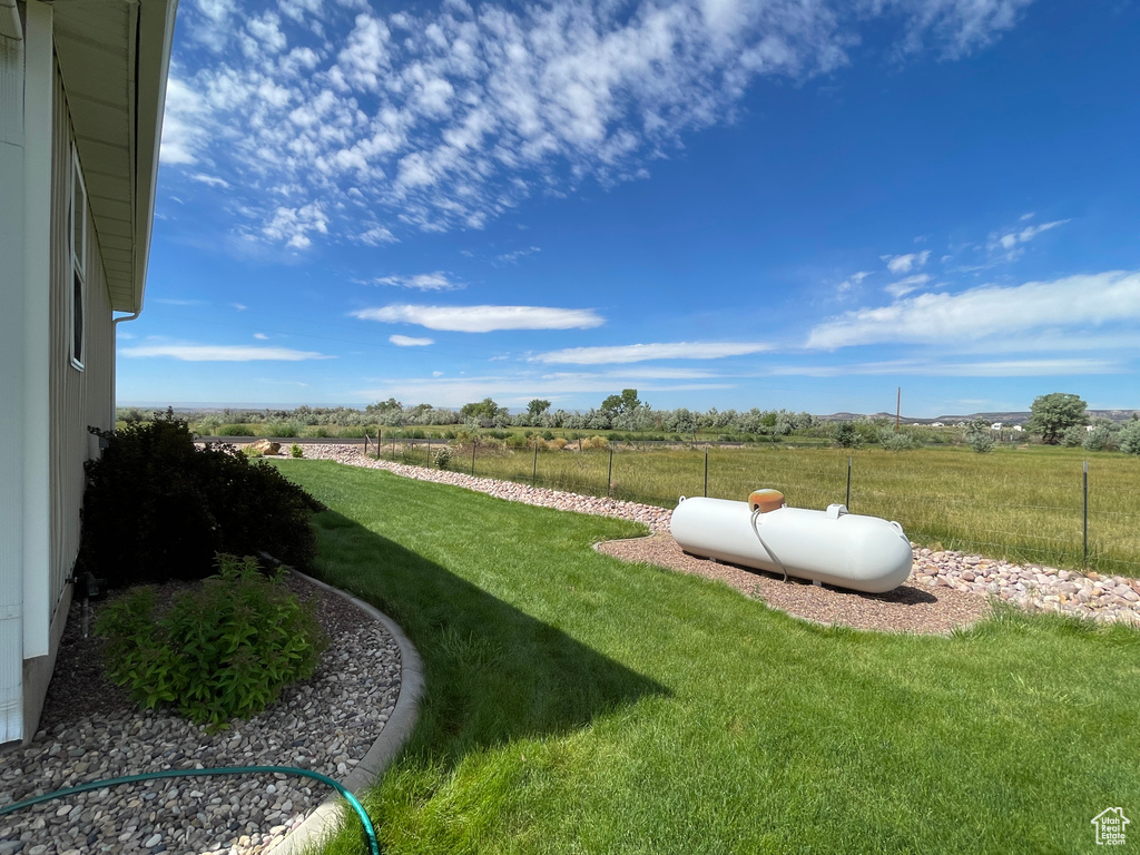 View of yard with a rural view