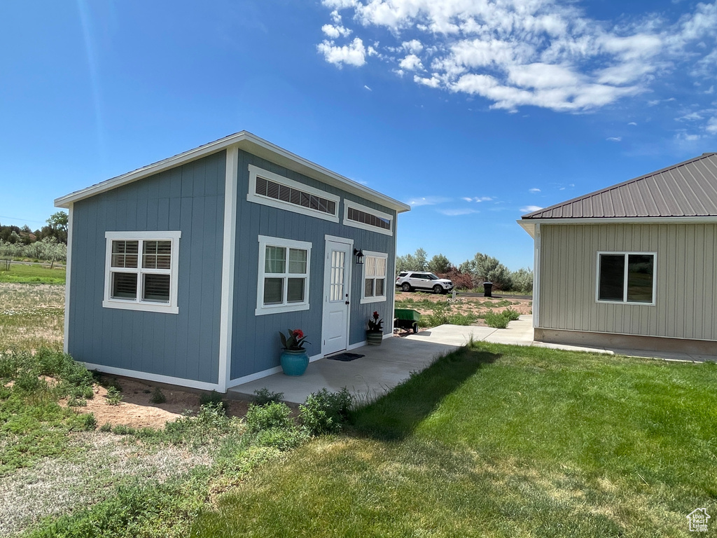 Rear view of property featuring a yard