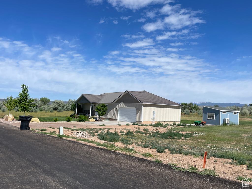 Single story home featuring driveway and an attached garage