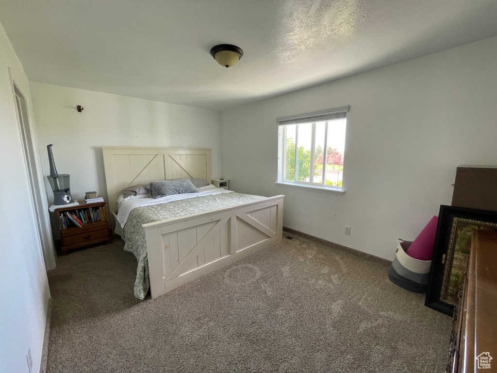 Bedroom with carpet and baseboards