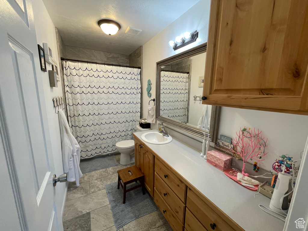 Full bathroom with vanity and a shower with curtain