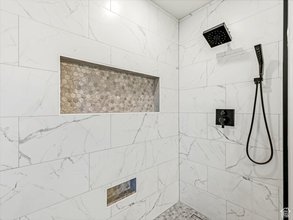 Full bath featuring a tile shower