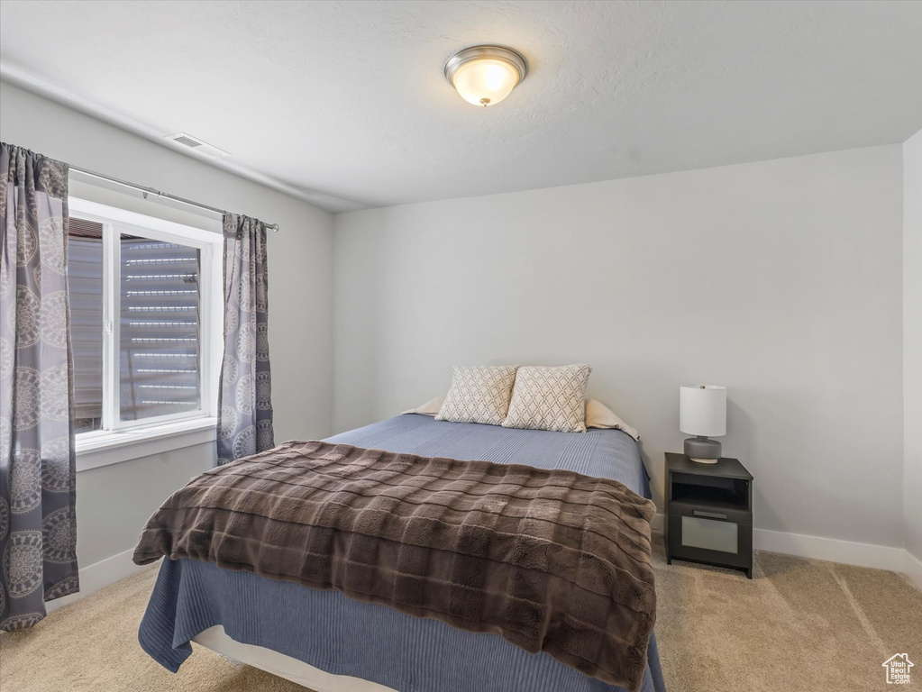 Carpeted bedroom featuring baseboards