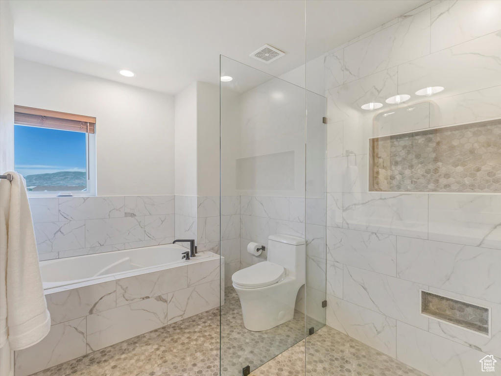Bathroom with a bath, a walk in shower, recessed lighting, and tile patterned floors