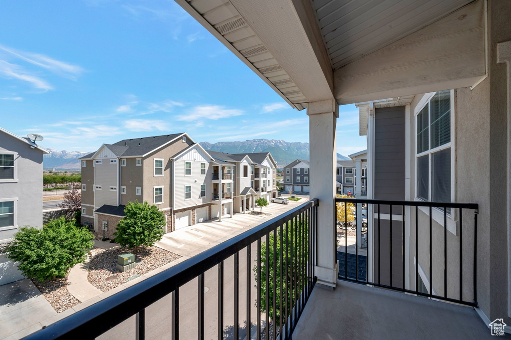 Balcony featuring a residential view and a mountain view