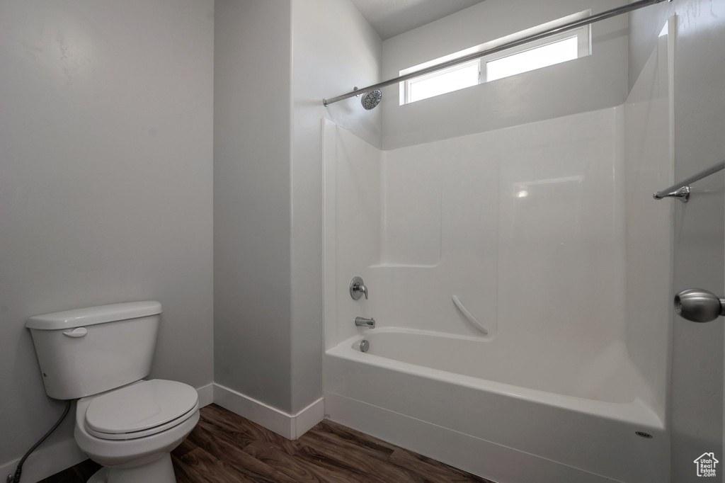 Full bathroom with shower / tub combination and wood finished floors