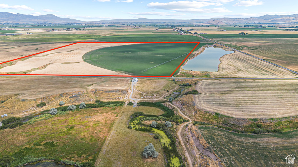 Aerial view of property's location featuring a water and mountain view and property parcel outlined