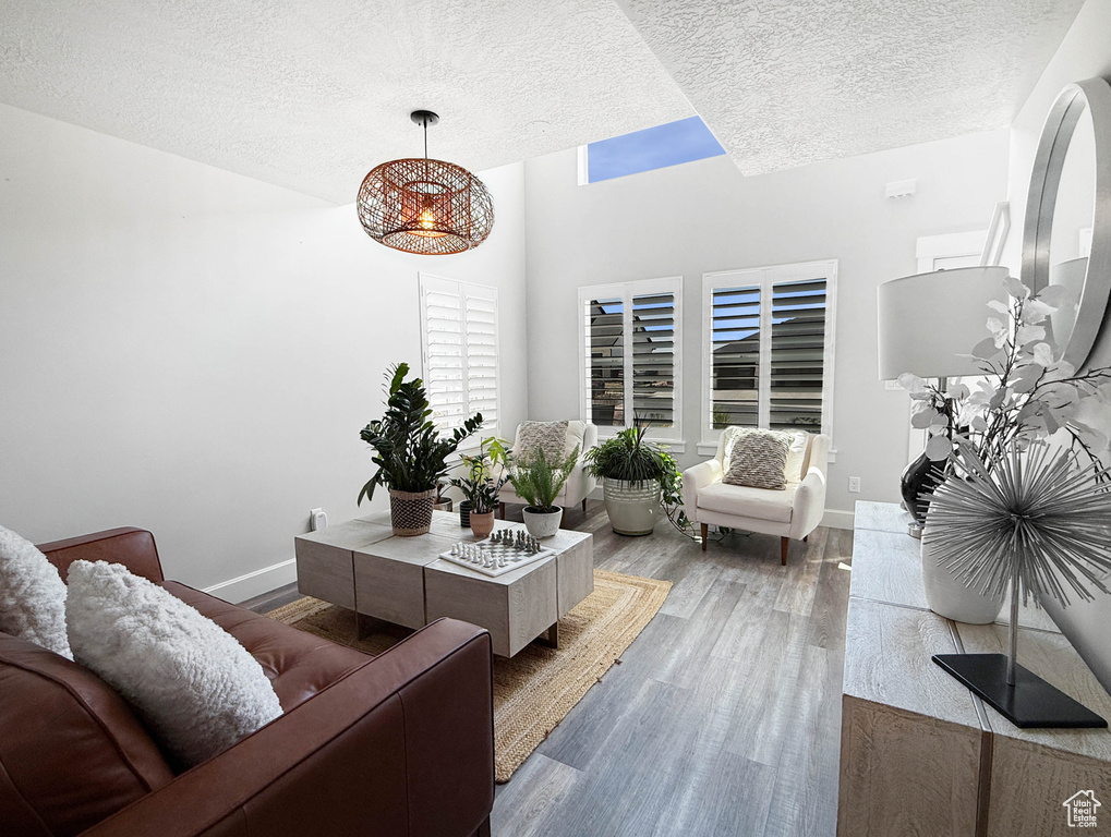 Living area with a textured ceiling and wood finished floors