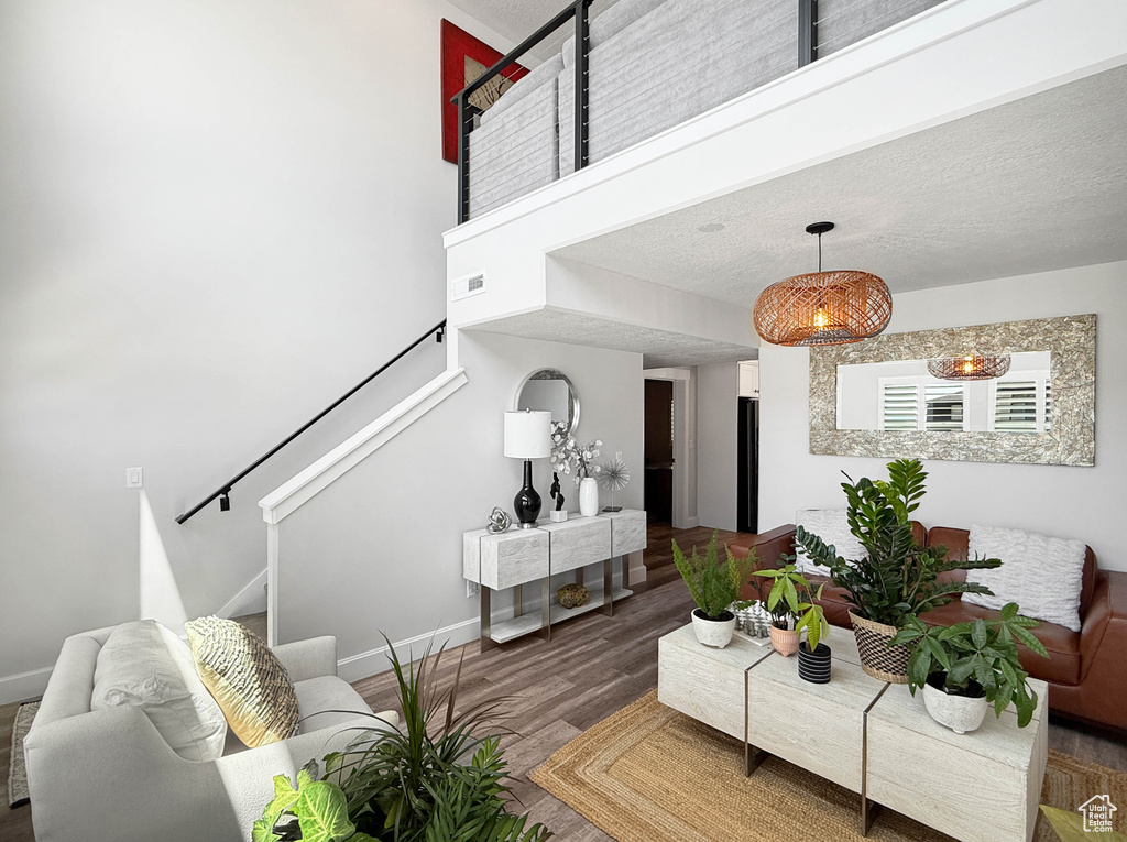 Living room with stairway and wood finished floors