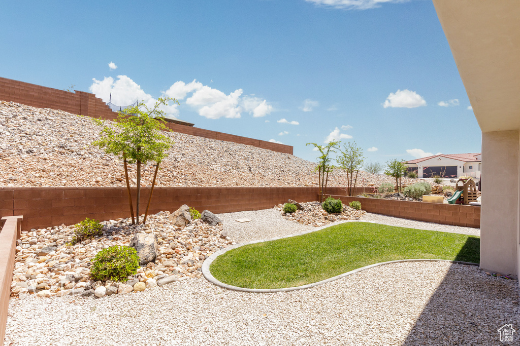 Fenced backyard with a patio area