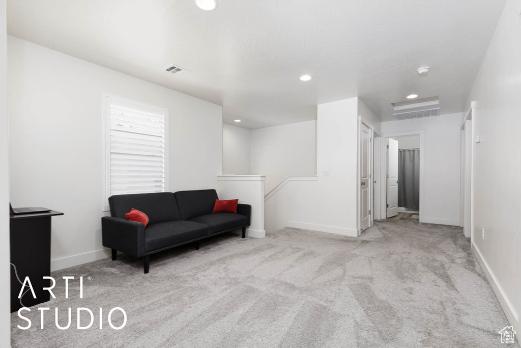 Living area with an upstairs landing, carpet, and recessed lighting