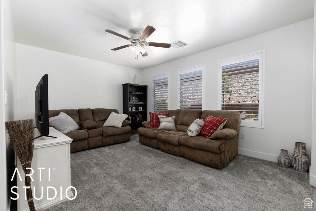 Living room featuring carpet and ceiling fan