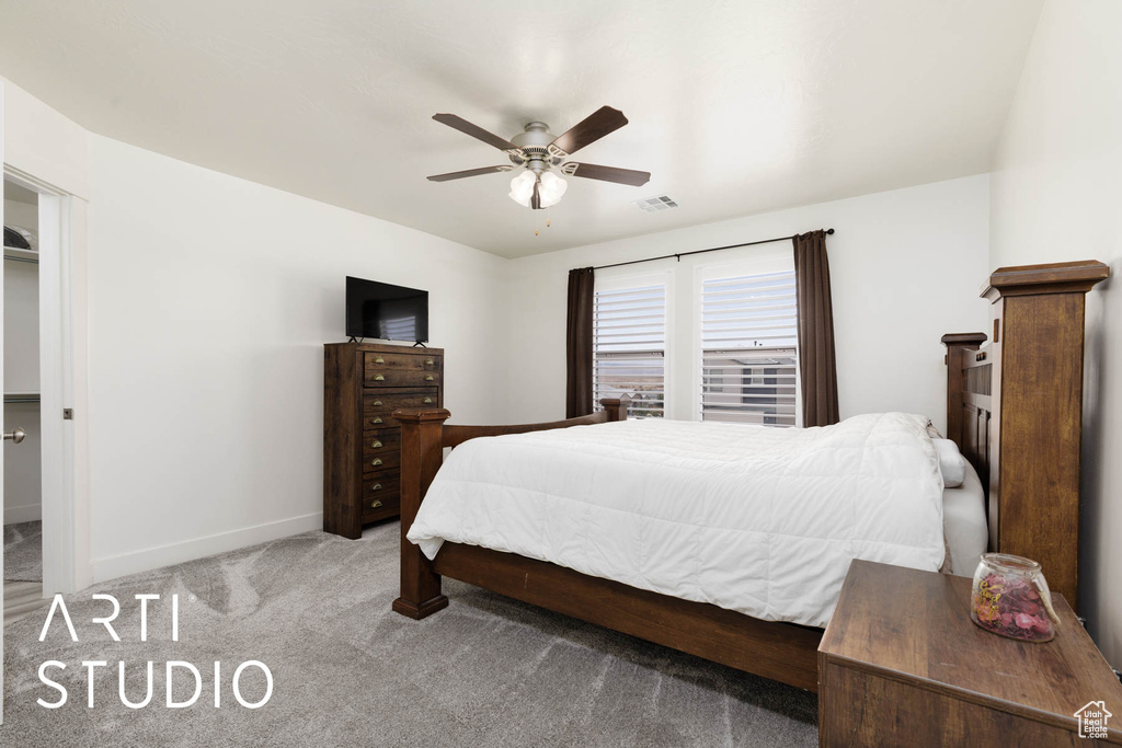 Bedroom with carpet floors and a ceiling fan