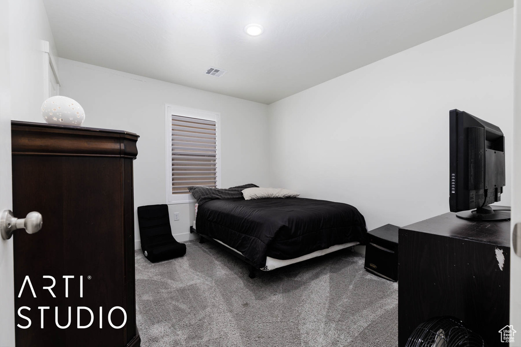 Bedroom featuring carpet flooring and baseboards