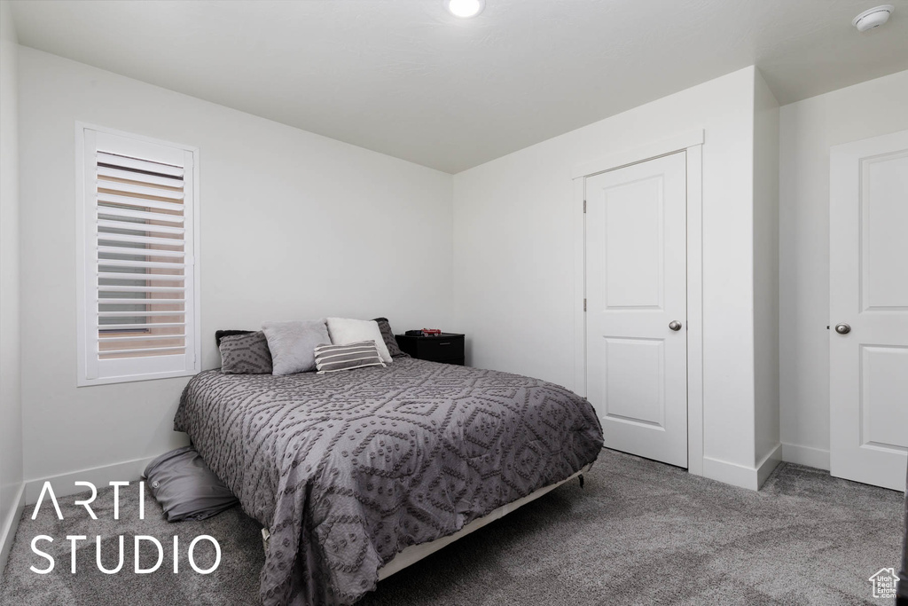 Bedroom featuring carpet flooring and baseboards