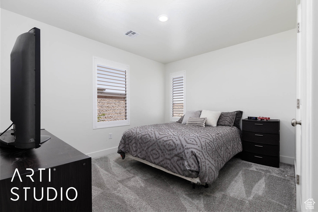 Carpeted bedroom with baseboards