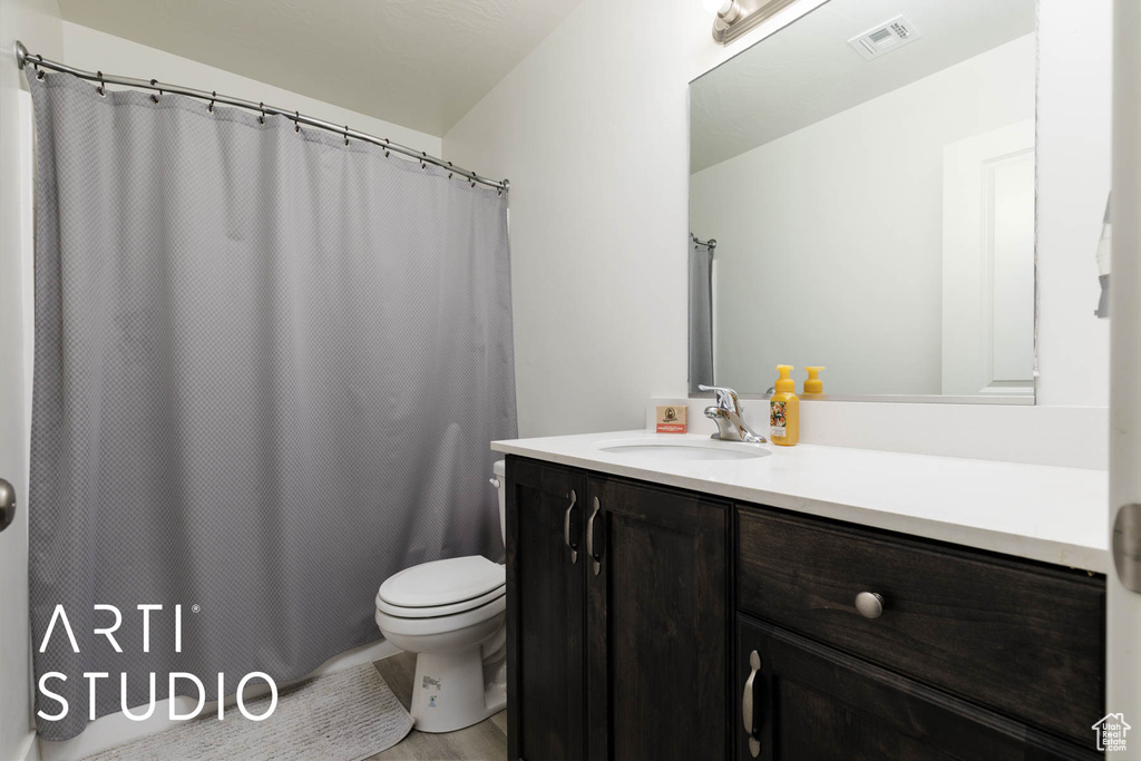 Bathroom featuring vanity and curtained shower