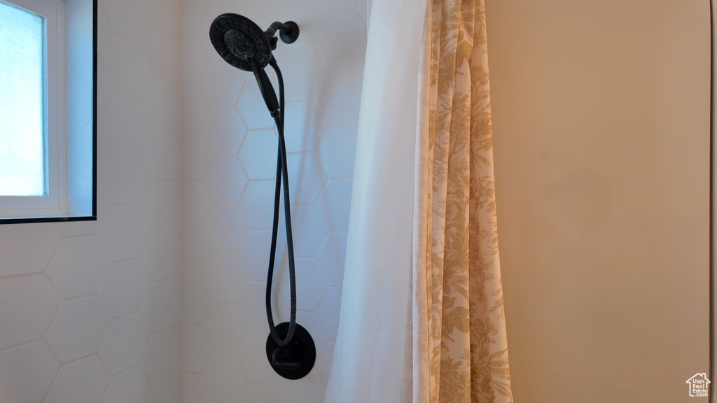 Bathroom view of a shower with curtain