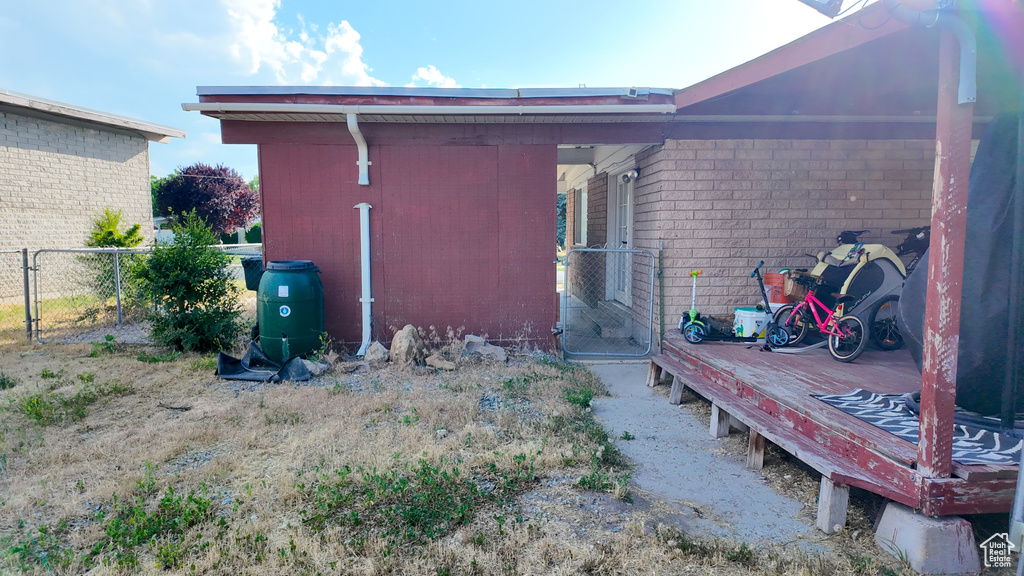 Rear view of property with brick siding and a gate