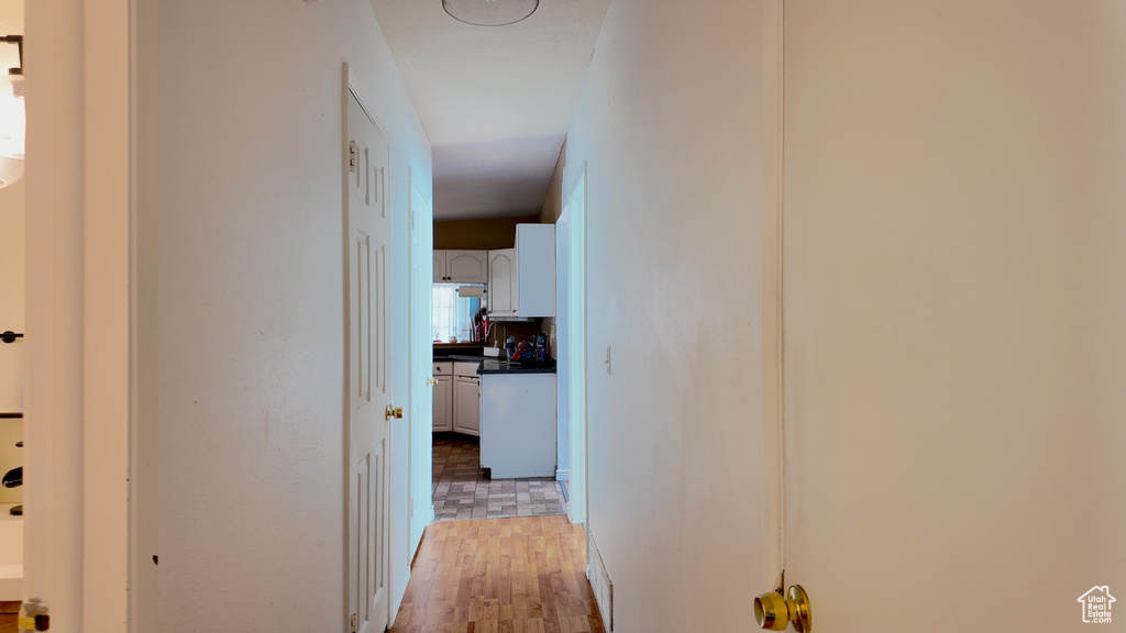 Corridor featuring light wood finished floors