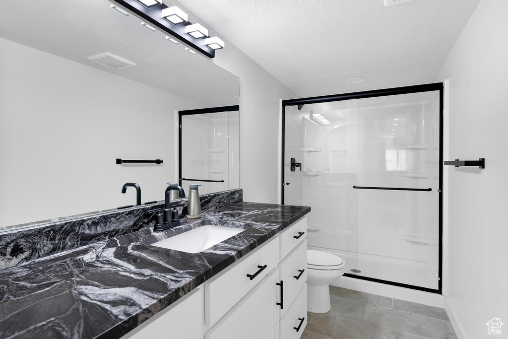 Bathroom featuring vanity and a shower stall