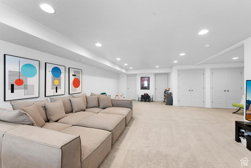 Carpeted living room featuring recessed lighting