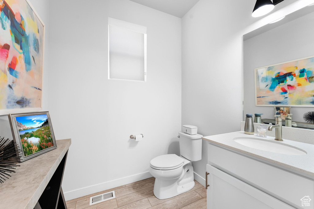 Bathroom featuring vanity and wood finished floors