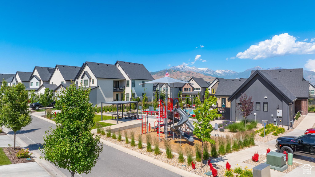 Community playground with a residential view and a mountain view