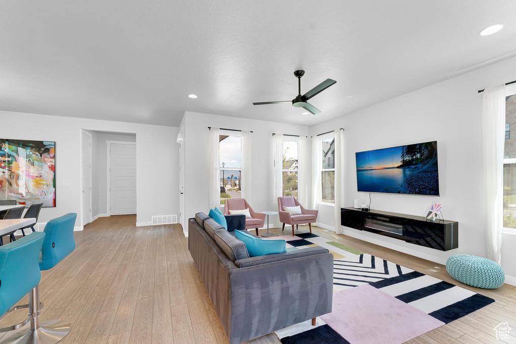 Living area featuring ceiling fan, hardwood / wood-style flooring, and recessed lighting
