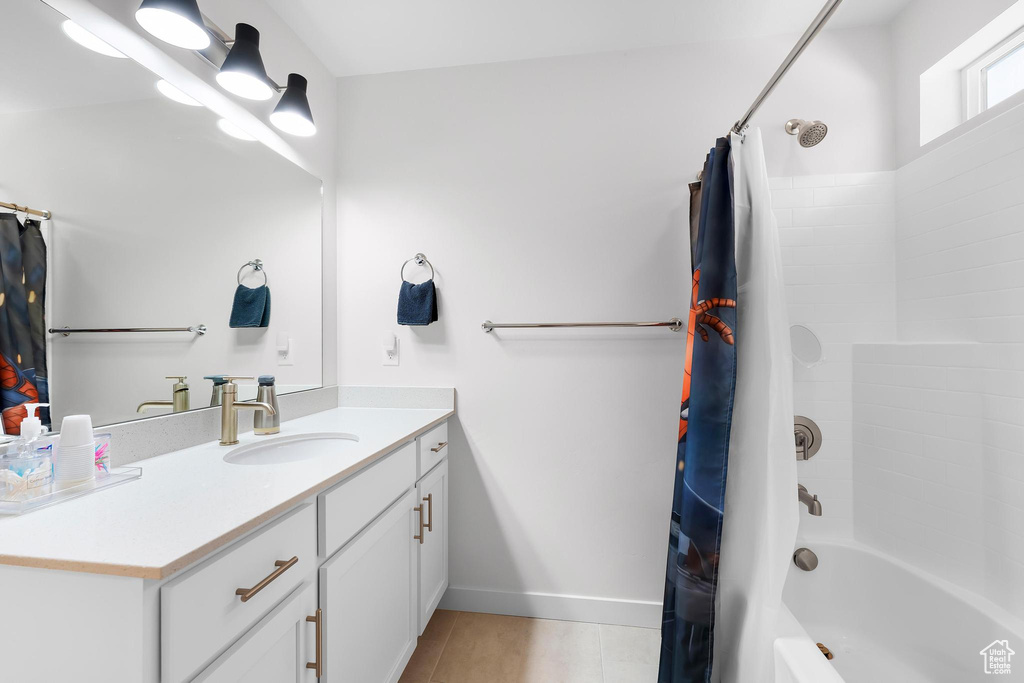 Full bath with vanity, shower / bath combination with curtain, and tile patterned flooring