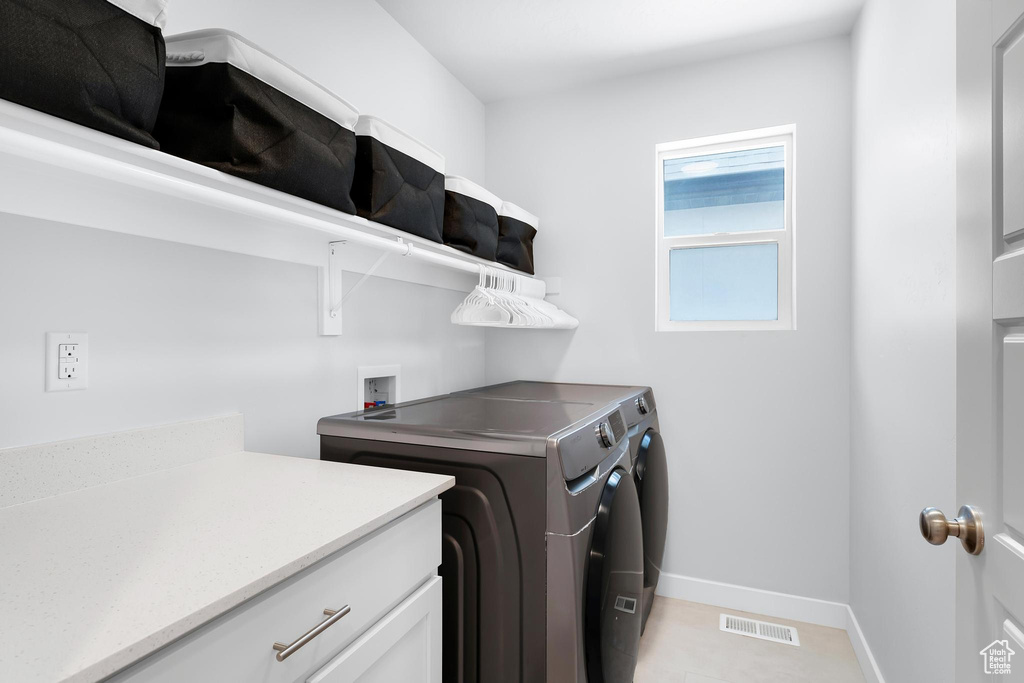 Laundry room featuring washing machine and clothes dryer and baseboards