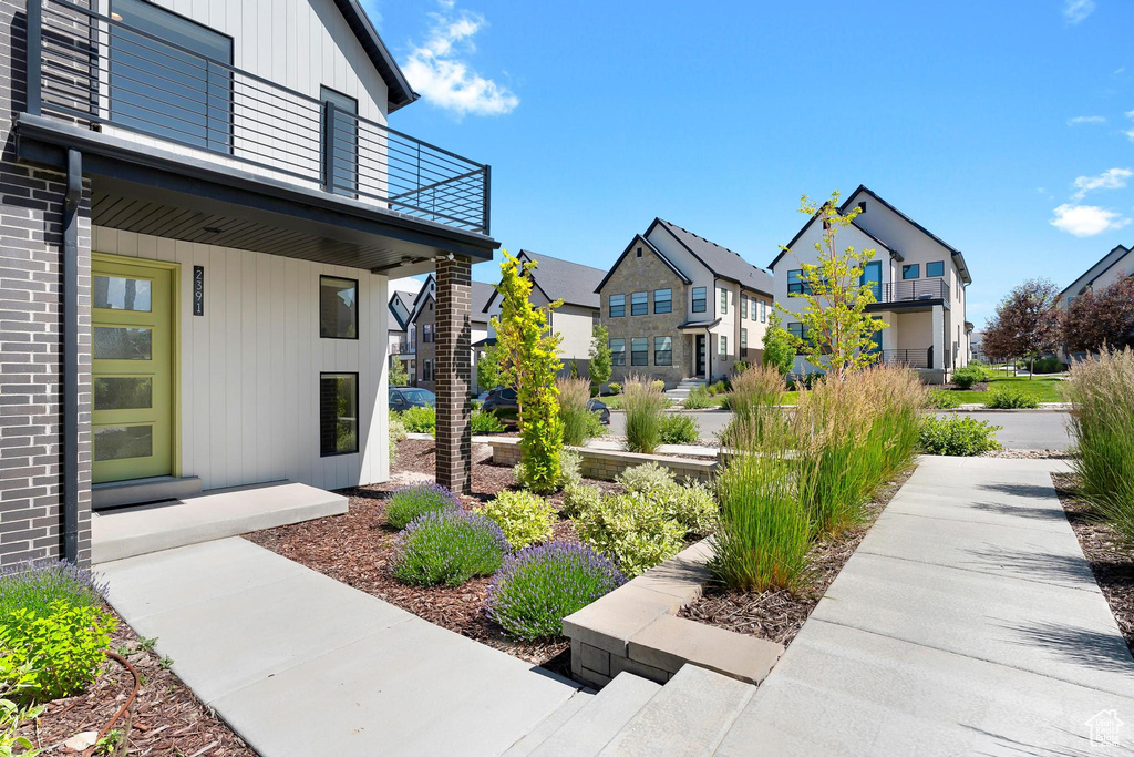 View of yard featuring a residential view and a balcony