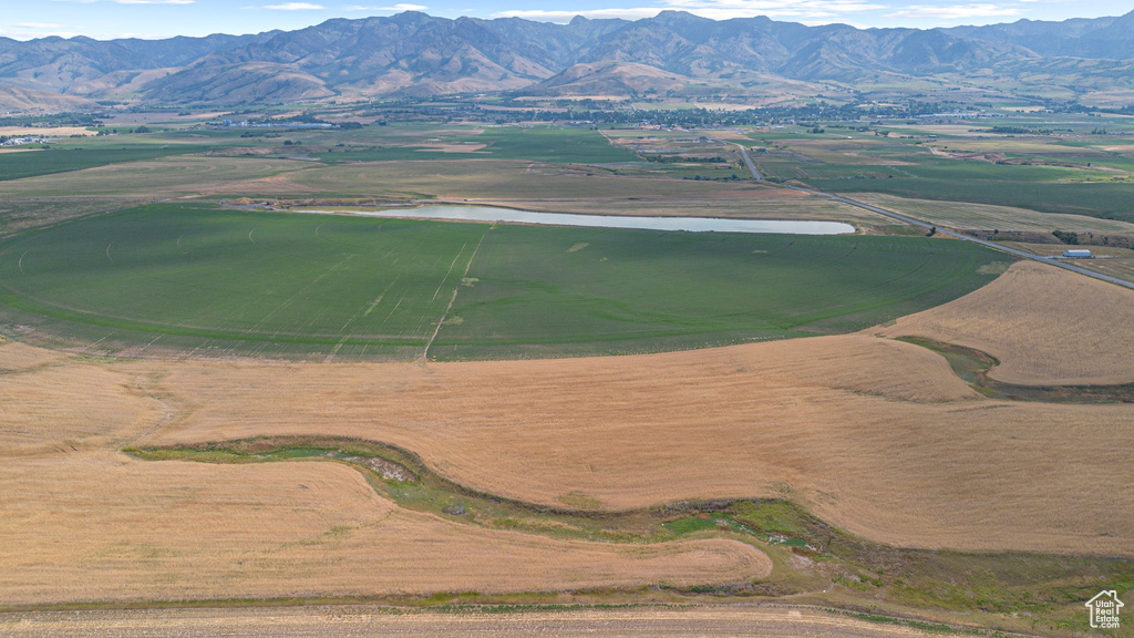 Aerial view of property and surrounding area featuring a water and mountain view