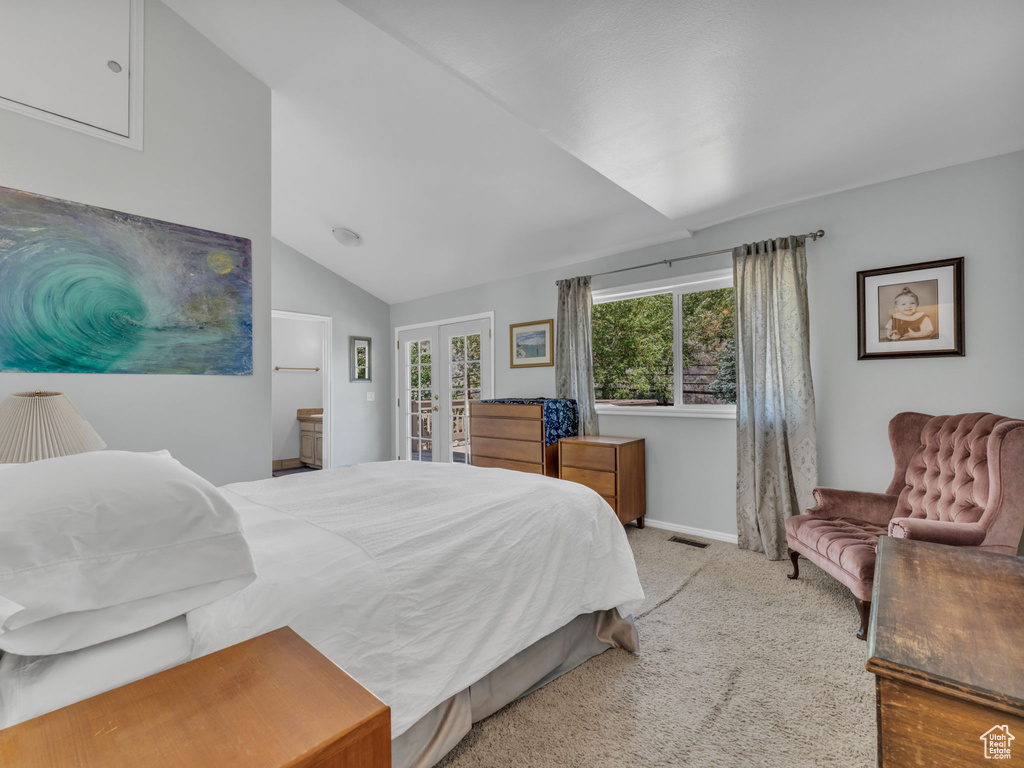 Carpeted bedroom with lofted ceiling, french doors, and access to outside