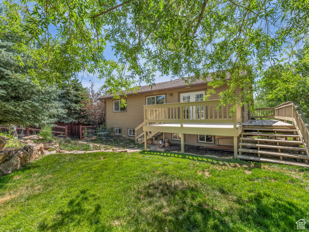 Back of house with stairway and a deck