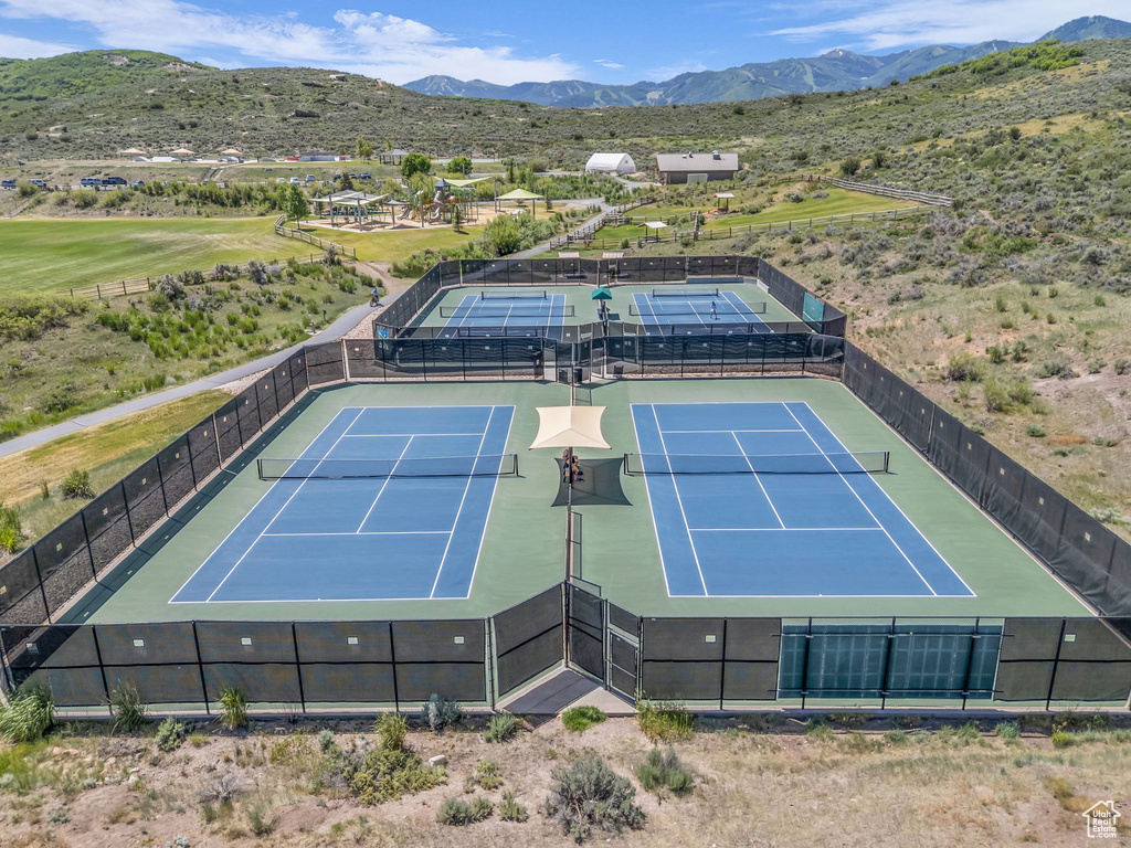 View of tennis court featuring a mountain view