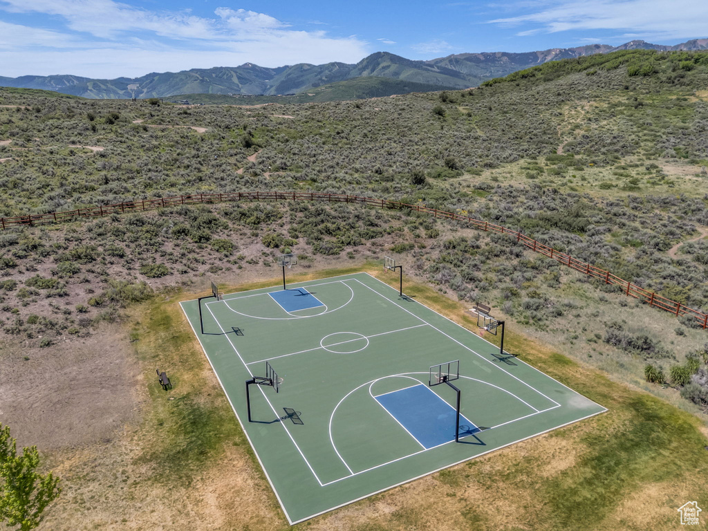 View of sport court featuring community basketball court, a mountain view, and view of desert