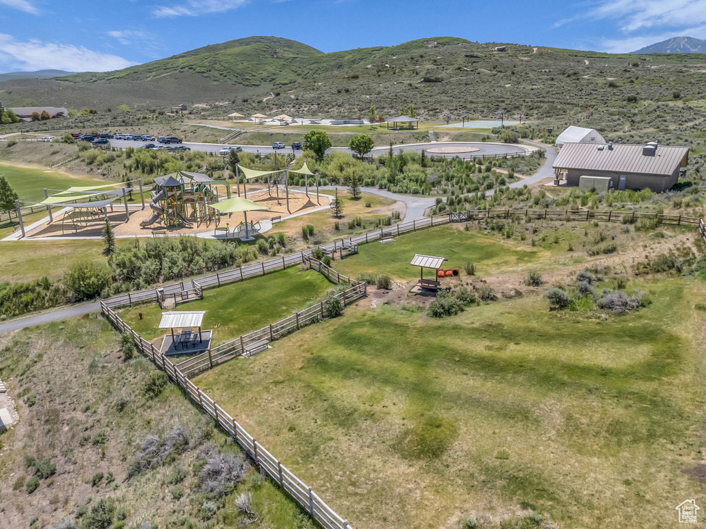 Drone / aerial view of a mountain backdrop and a park