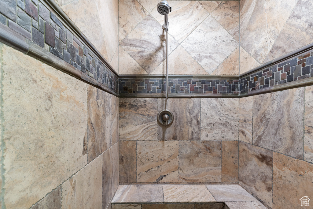 Full bath featuring tiled shower