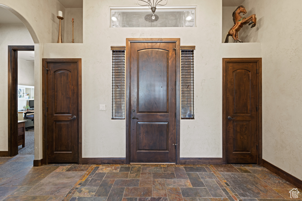 Foyer entrance featuring stone tile floors and arched walkways