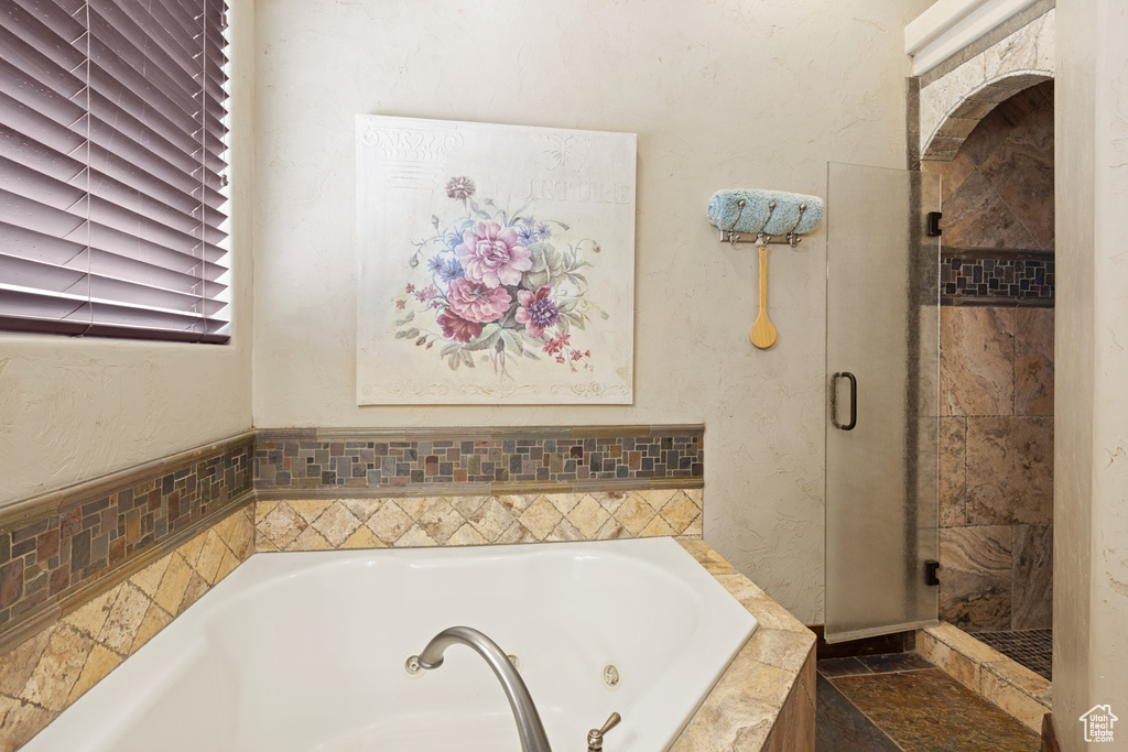 Full bathroom with a jetted tub and a shower stall