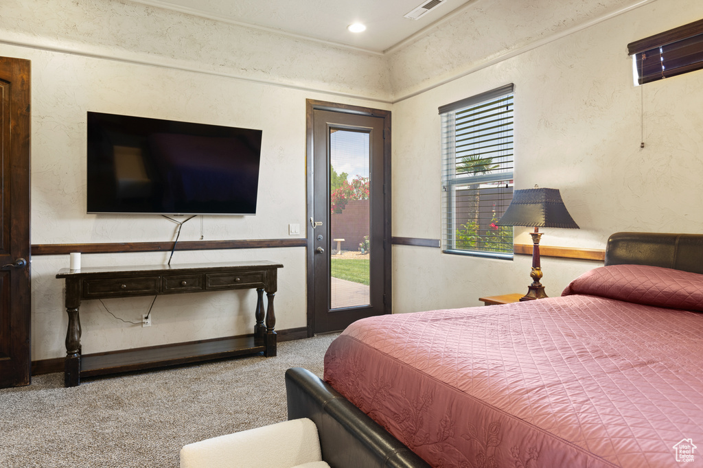 Carpeted bedroom with access to exterior