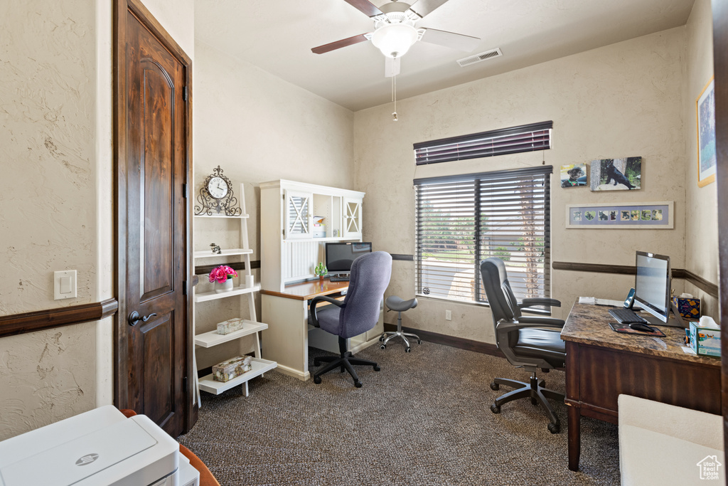 Office with carpet floors, a ceiling fan, and a textured wall