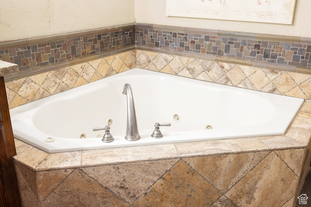 Full bath featuring a whirlpool tub