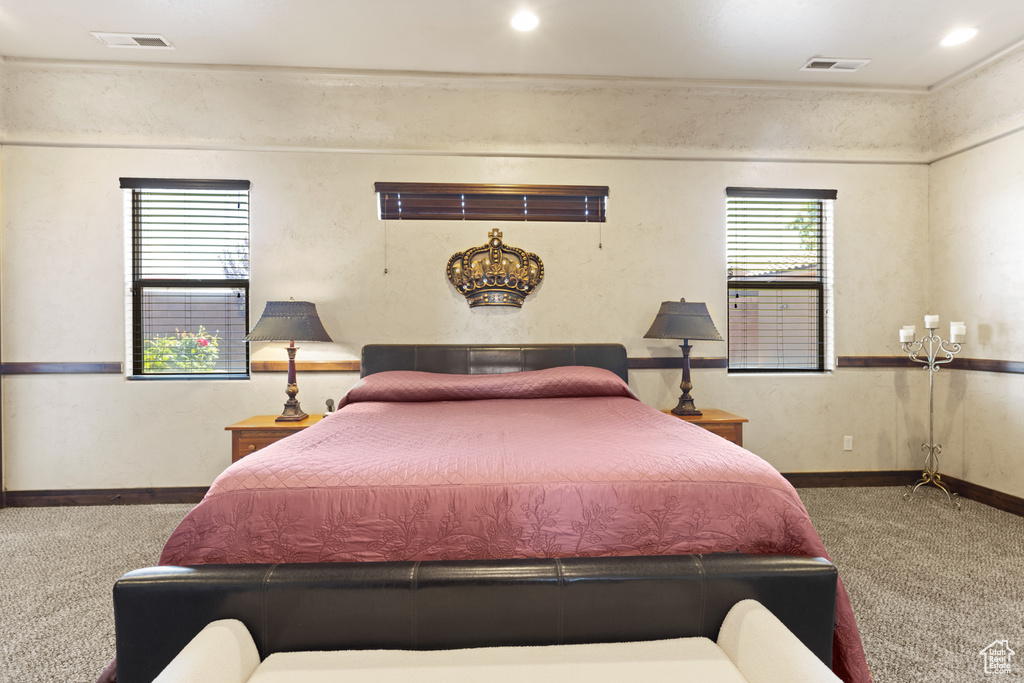 Carpeted bedroom featuring baseboards