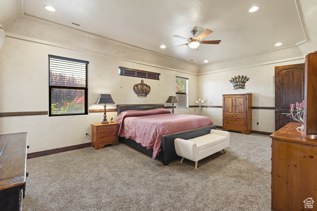 Carpeted bedroom with recessed lighting and ceiling fan